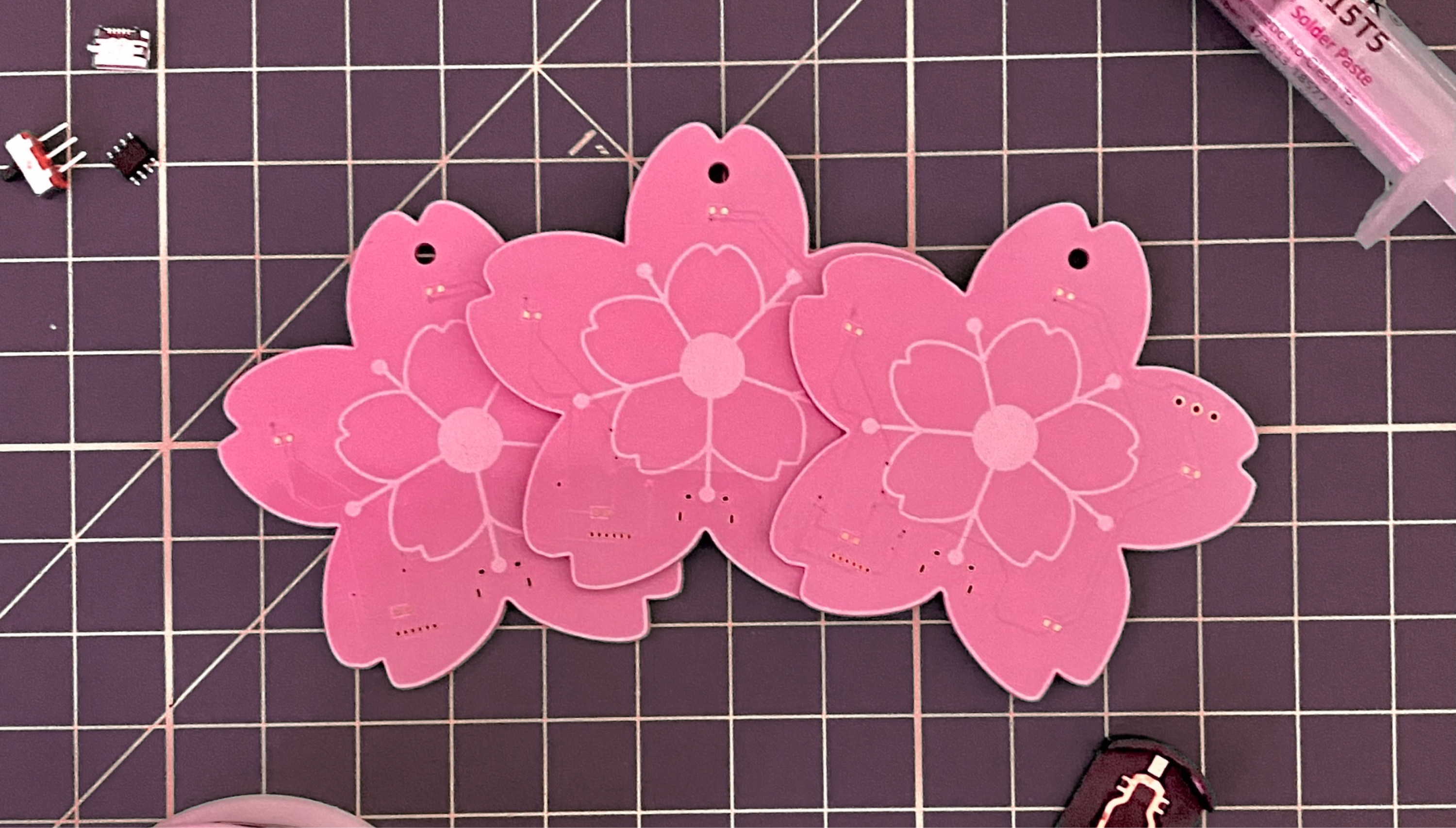 A big image of several pink flower-shaped PCBs.